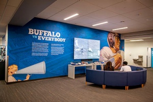 Picture of the large-scale video screen on the 3rd floor of Silverman Library. 