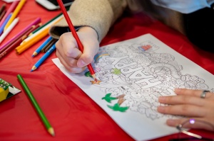 Student coloring a coloring page. 