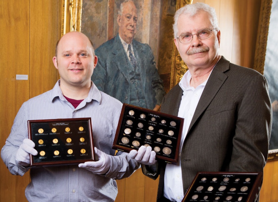 From left: Philip Kiernan of the UB Department of Classics and Michael Basinski Curator of the Poetry Collection and Director of Special Collections. Thomas Lockwood’s portrait hangs on the wall in the Special Collections Reading Room. 