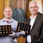 From left: Philip Kiernan of the UB Department of Classics and Michael Basinski Curator of the Poetry Collection and Director of Special Collections. Thomas Lockwood&rsquo;s portrait hangs on the wall in the Special Collections Reading Room. 