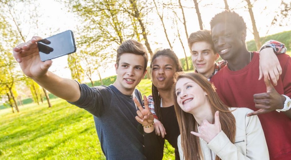Diverse group of young people posing for a selfie. 