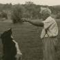 In black and white, Robert Frost with his dog, Gillie. 