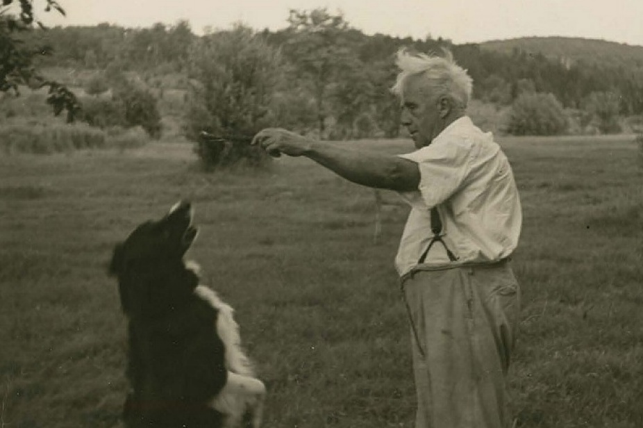In black and white, Robert Frost with his dog, Gillie. 