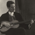 Photo of James Joyce playing the guitar. 