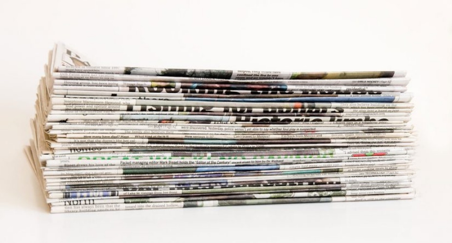 Photo of a stack of newspapers. 