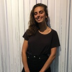 Claire Tranchino in front of Norma Cole&rsquo;s Collective Memory (2004), the Poetry Collection, 420 Capen Hall. 