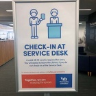 Library check-in service desk sign. 