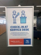 Library check-in service desk sign. 