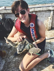 Ally Wood holding a turtle. 