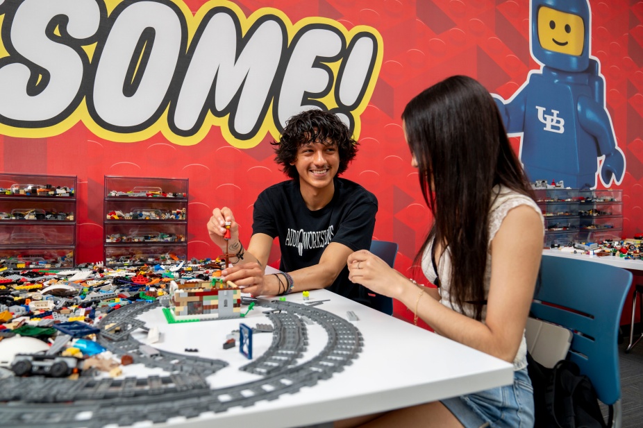 two students in the LEGO area. 
