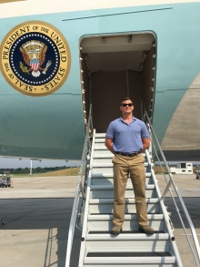 Spencer stands on the stairs of Air Force One. 