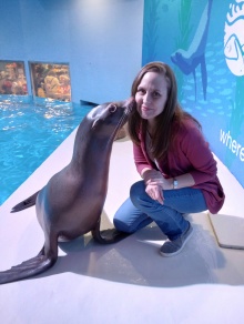 Heather receives a kiss on the cheek from a sea lion. 